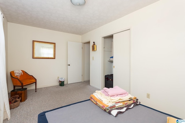 carpeted bedroom featuring a textured ceiling