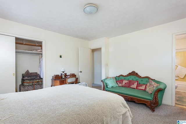 carpeted bedroom with a closet and connected bathroom