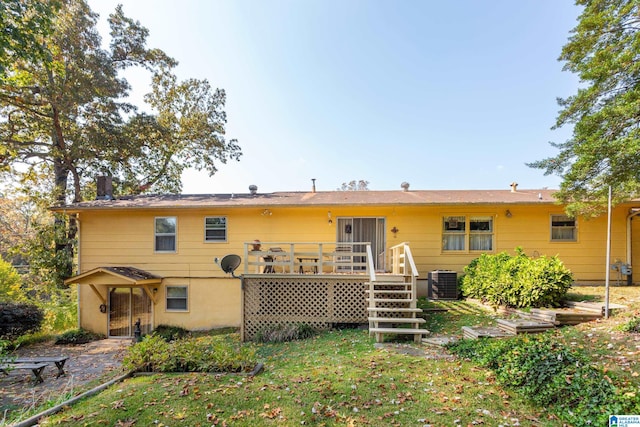 back of house featuring central AC and a deck