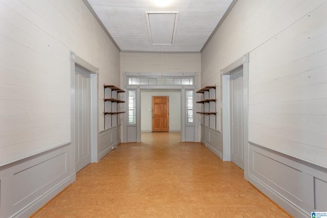 corridor featuring ornamental molding and light wood-type flooring