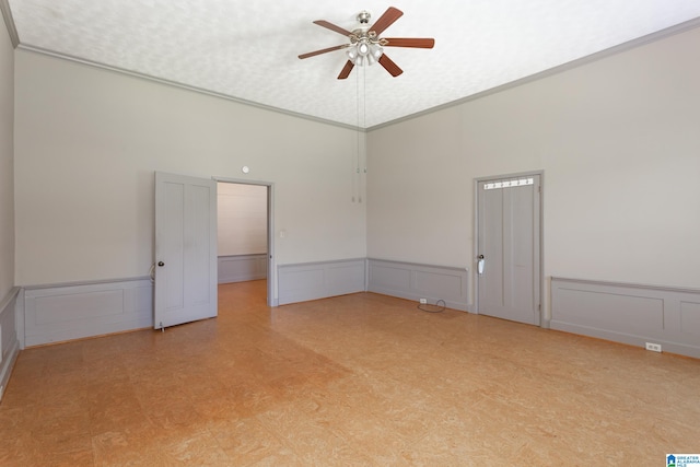 unfurnished room featuring ceiling fan, crown molding, a textured ceiling, and a high ceiling