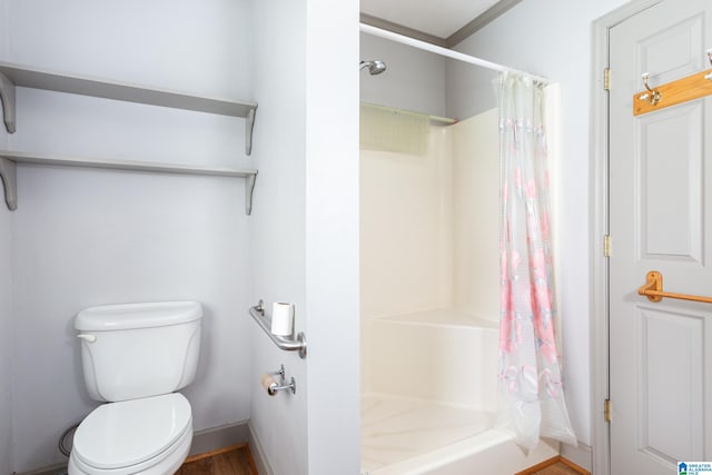 bathroom featuring toilet and a shower with curtain