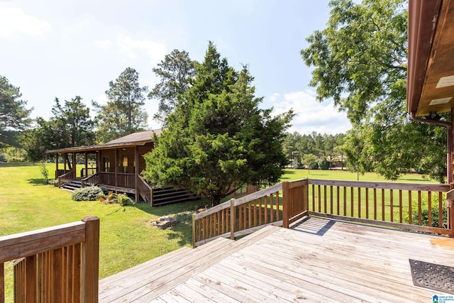 wooden terrace featuring a yard