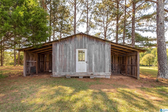 view of outdoor structure featuring a lawn