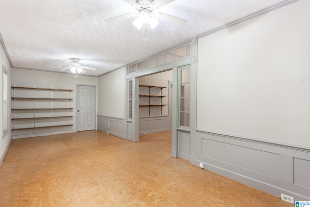 spare room featuring crown molding, a textured ceiling, and ceiling fan