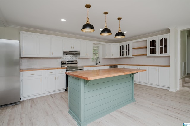 kitchen featuring butcher block counters, white cabinets, pendant lighting, and stainless steel appliances