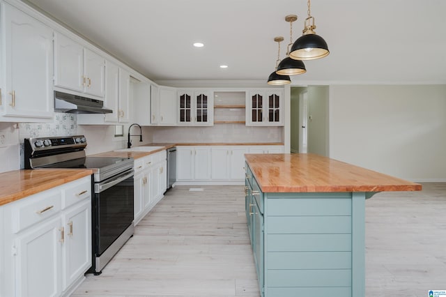 kitchen with stainless steel appliances, white cabinetry, decorative light fixtures, a center island, and wood counters