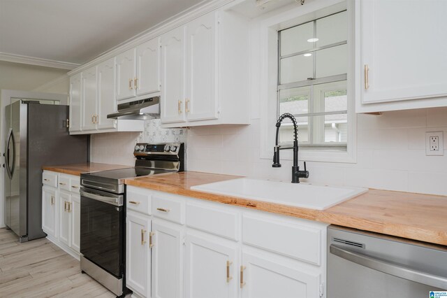 kitchen with appliances with stainless steel finishes, sink, and white cabinets