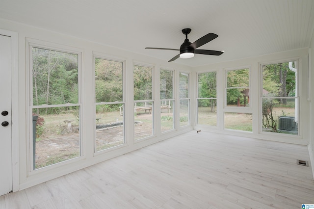 unfurnished sunroom featuring ceiling fan and plenty of natural light