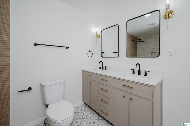 bathroom with toilet, vanity, and walk in shower