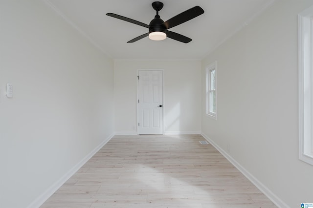 spare room with ornamental molding, light hardwood / wood-style floors, and ceiling fan