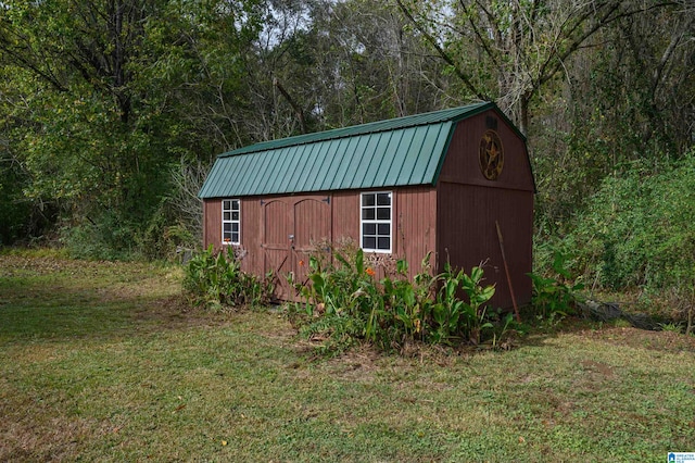 view of outbuilding with a yard