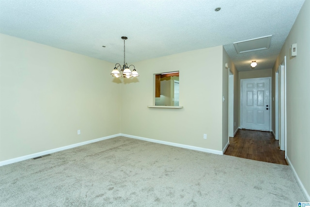 spare room with carpet flooring and a textured ceiling