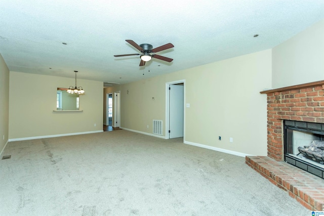 unfurnished living room featuring carpet, a fireplace, a textured ceiling, and ceiling fan