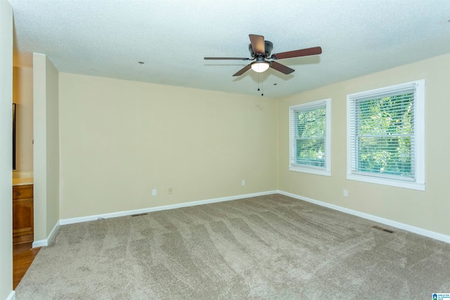 unfurnished room with carpet, a textured ceiling, and ceiling fan