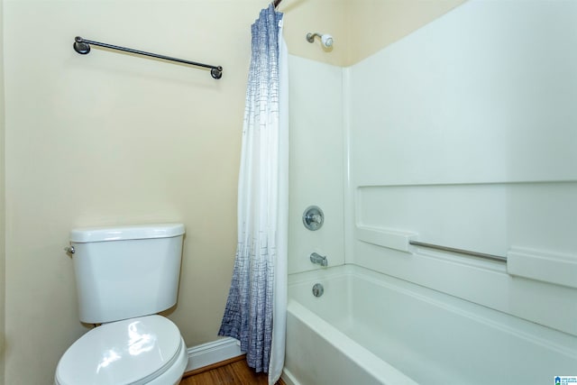 bathroom featuring toilet, wood-type flooring, and shower / bathtub combination with curtain