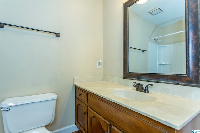 bathroom with vanity, toilet, and walk in shower