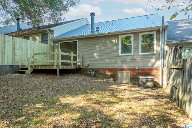 rear view of house with a wooden deck