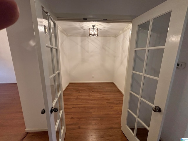 corridor featuring dark hardwood / wood-style floors, french doors, and a notable chandelier