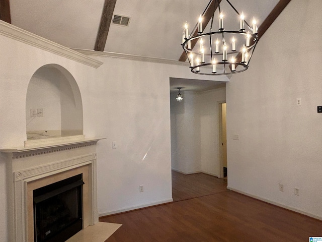 unfurnished living room featuring dark wood-type flooring, a notable chandelier, and crown molding