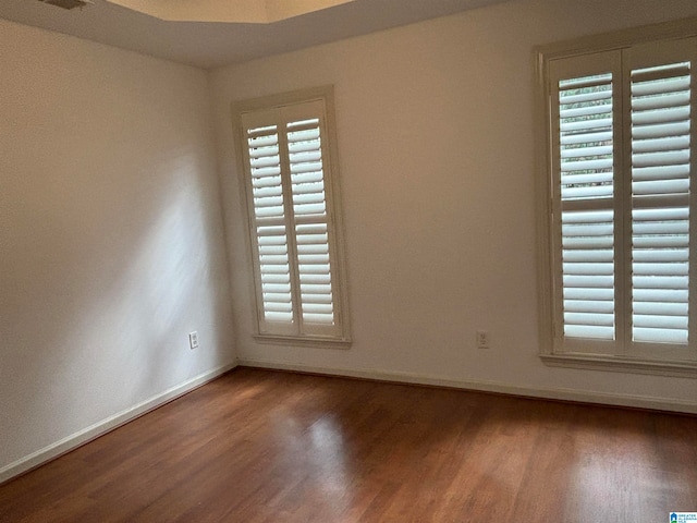 unfurnished room featuring dark wood-type flooring