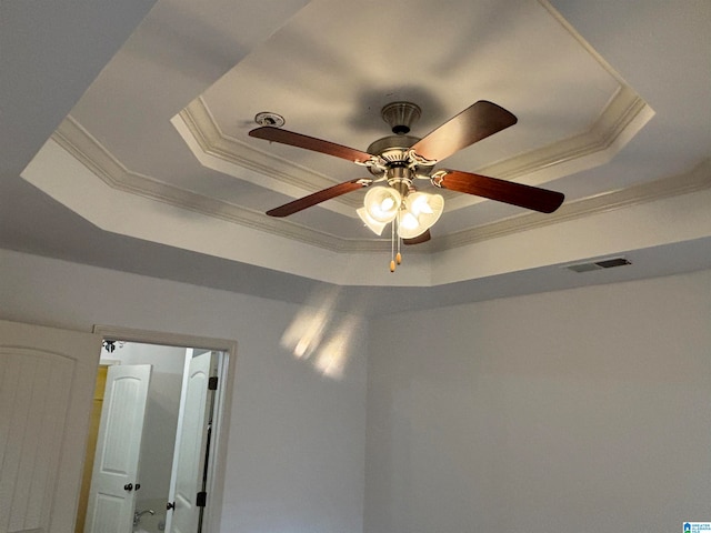 room details featuring ornamental molding, ceiling fan, and a tray ceiling