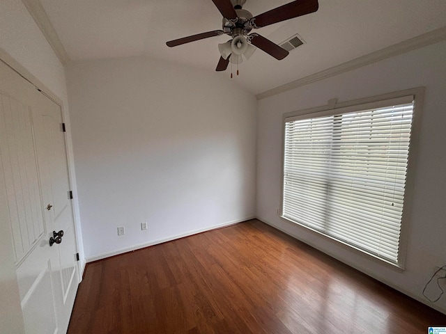 empty room with lofted ceiling, hardwood / wood-style flooring, and ceiling fan