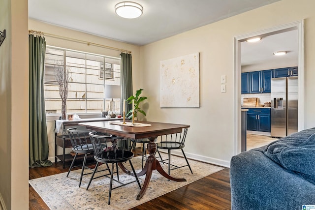 dining space with wood-type flooring