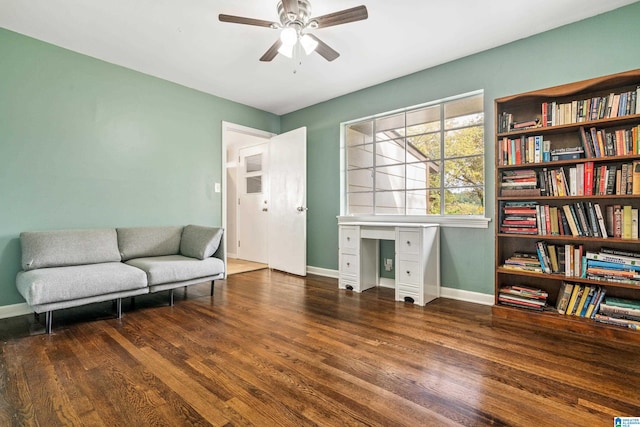 living area with ceiling fan and dark hardwood / wood-style floors