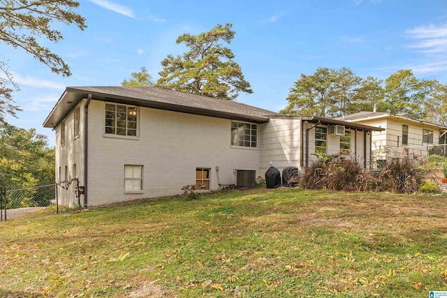 view of side of home featuring a lawn and cooling unit