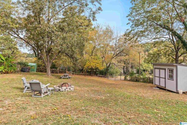 view of yard with a shed and a fire pit