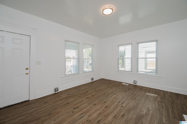 unfurnished room featuring dark hardwood / wood-style flooring