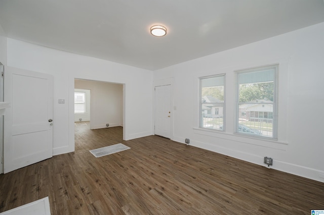 unfurnished room with dark wood-type flooring