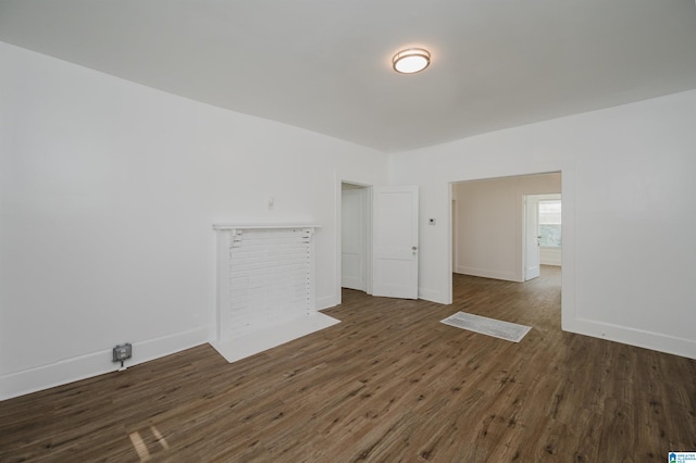 empty room with dark hardwood / wood-style flooring