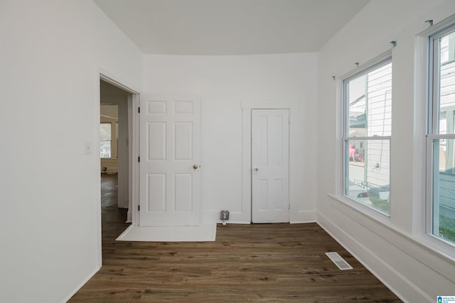 unfurnished room featuring dark wood-type flooring