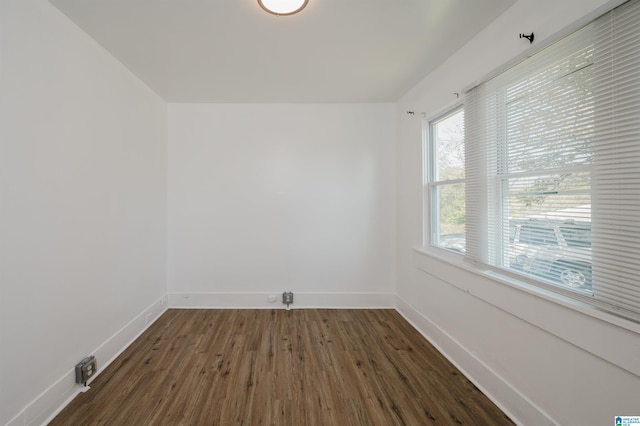 empty room with dark hardwood / wood-style floors