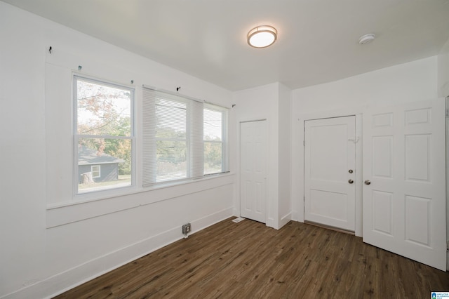 empty room with dark hardwood / wood-style floors