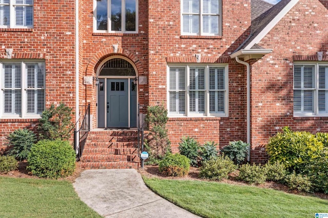 doorway to property with a yard