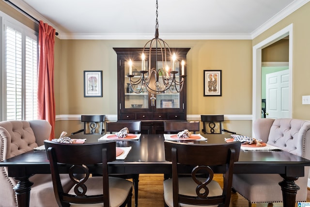 dining room with a notable chandelier and ornamental molding