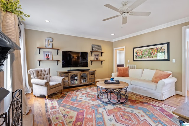 living room featuring ceiling fan, crown molding, and wood-type flooring