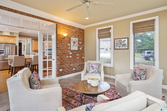 living room with crown molding, light tile patterned flooring, and ceiling fan