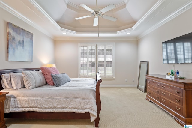 bedroom featuring light carpet, ornamental molding, a raised ceiling, and ceiling fan