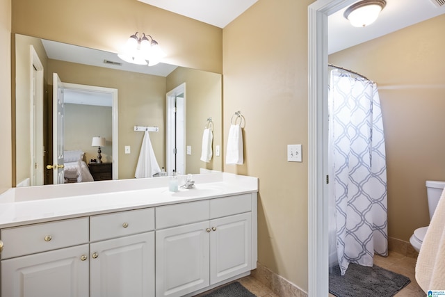 bathroom featuring vanity, toilet, and tile patterned flooring