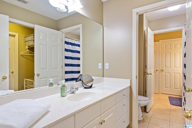 bathroom featuring vanity, toilet, and tile patterned flooring