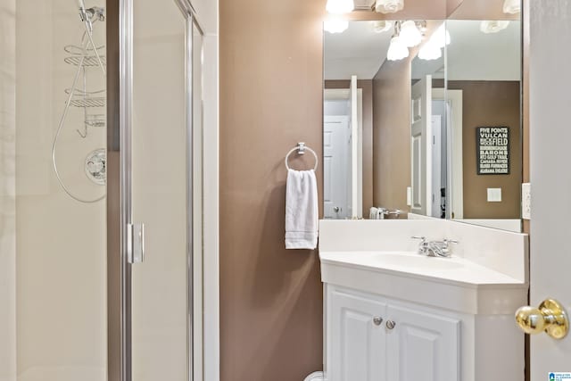 bathroom featuring vanity and a shower with shower door