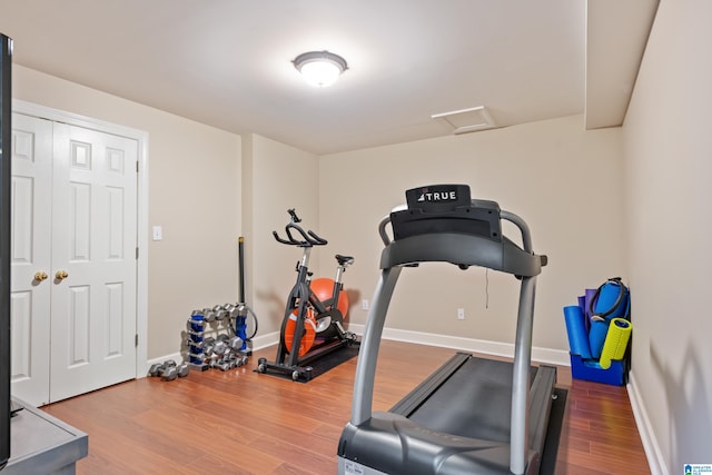 exercise room featuring hardwood / wood-style floors