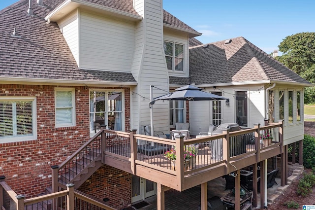 rear view of property featuring a wooden deck