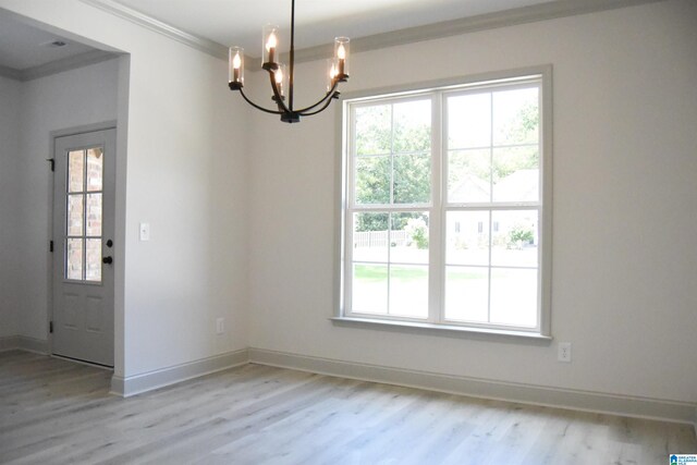 unfurnished dining area with a notable chandelier, baseboards, crown molding, and light wood-style floors