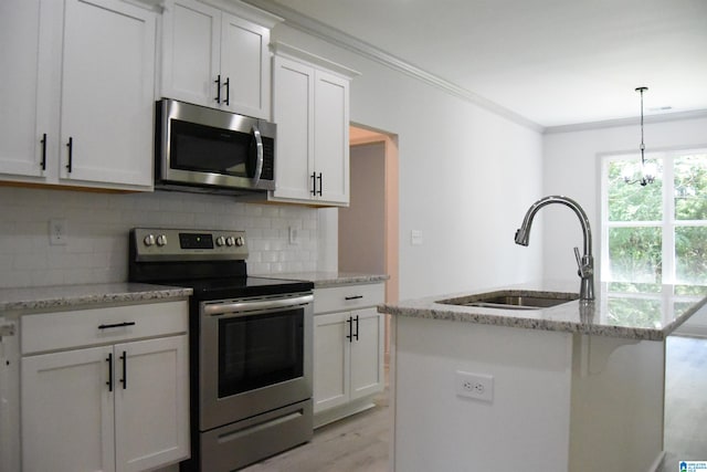 kitchen with light stone counters, a sink, appliances with stainless steel finishes, crown molding, and tasteful backsplash