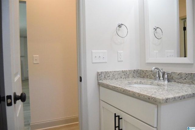 bathroom with vanity and baseboards